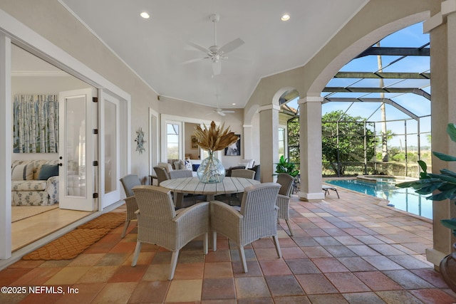 view of patio with outdoor dining space, an in ground hot tub, an outdoor pool, ceiling fan, and a lanai