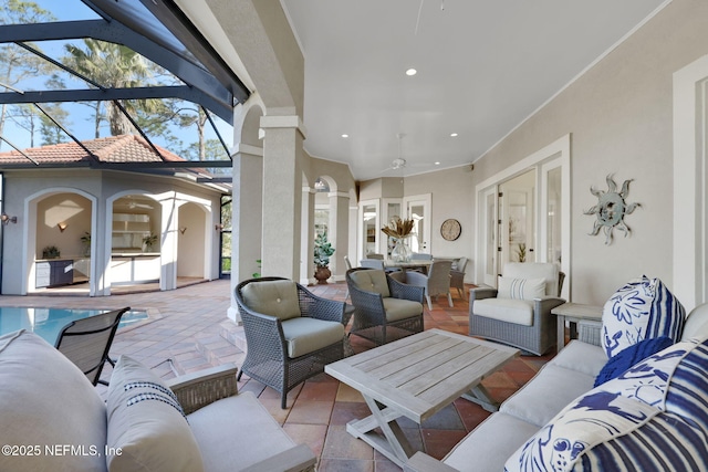 living room featuring recessed lighting, ceiling fan, ornamental molding, and decorative columns