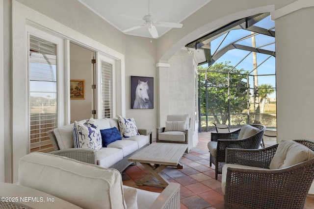 living area featuring plenty of natural light, a sunroom, and ceiling fan