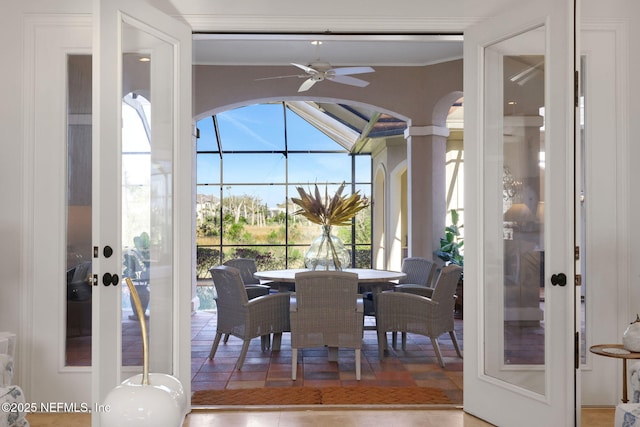 tiled dining room featuring ornamental molding, french doors, ceiling fan, and a sunroom