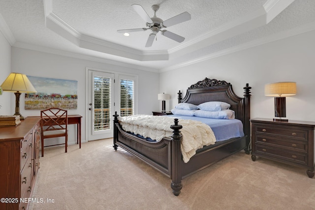 bedroom with a tray ceiling, access to exterior, a textured ceiling, crown molding, and light colored carpet