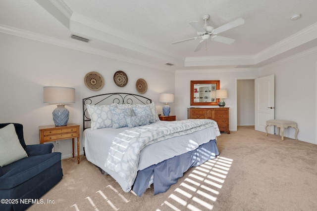 bedroom with visible vents, a raised ceiling, carpet flooring, and crown molding