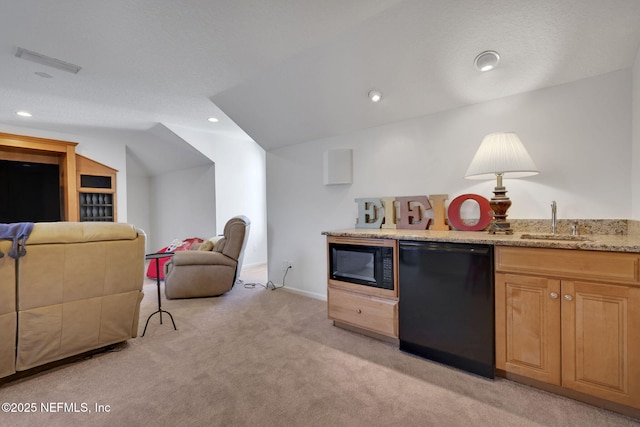 kitchen featuring visible vents, light carpet, black appliances, a sink, and light stone counters