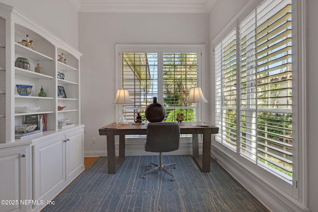 office featuring baseboards, plenty of natural light, ornamental molding, and dark carpet