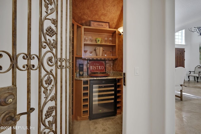 wine room featuring wine cooler and a dry bar