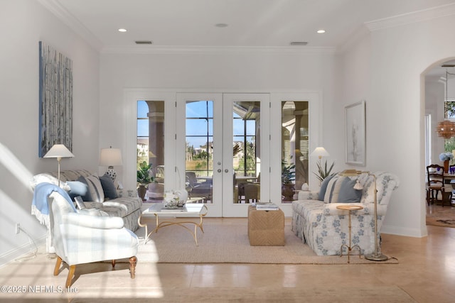 living area featuring ornamental molding, recessed lighting, french doors, arched walkways, and baseboards