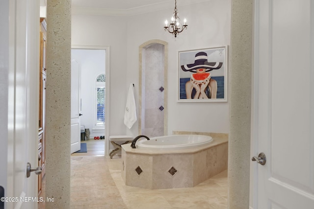 bathroom featuring a chandelier, a garden tub, and ornamental molding