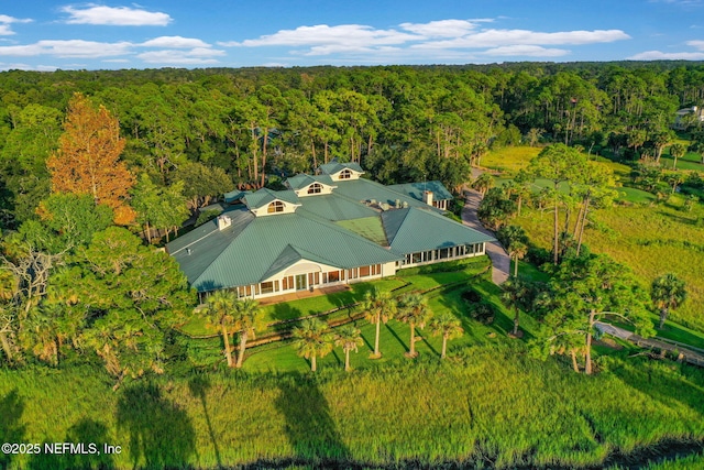 birds eye view of property featuring a wooded view