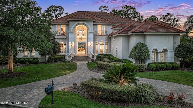 800 Hawks Nest Ct, Ponte Vedra Beach, FL 32082 - mediterranean / spanish-style house featuring a balcony, stucco siding, a front lawn, and a tiled roof