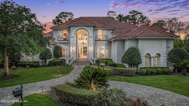 800 Hawks Nest Ct, Ponte Vedra Beach, FL 32082 - mediterranean / spanish-style home with a tile roof, stucco siding, a front lawn, and a balcony
