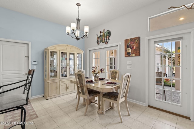 dining room with french doors, baseboards, an inviting chandelier, and light tile patterned flooring