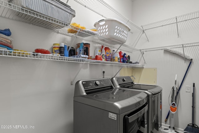 clothes washing area with separate washer and dryer and laundry area