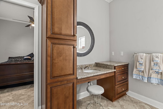 bathroom with ceiling fan, baseboards, and a sink