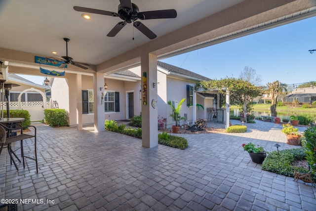 view of patio with outdoor dining space and a ceiling fan