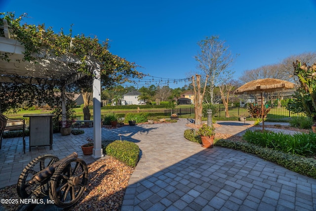 view of patio / terrace featuring fence and a pergola