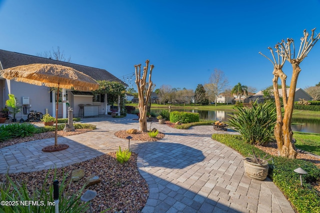 view of patio / terrace featuring a water view and an outdoor fire pit