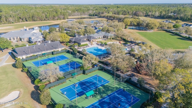 birds eye view of property with a view of trees and a water view