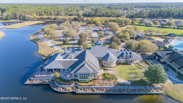 birds eye view of property featuring a wooded view, a water view, and a residential view