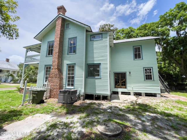 417 N 3rd St, Palatka, FL 32177 - rear view of property with a chimney and a balcony