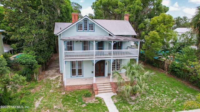 417 N 3rd St, Palatka, FL 32177 - view of front facade with a chimney, french doors, and metal roof