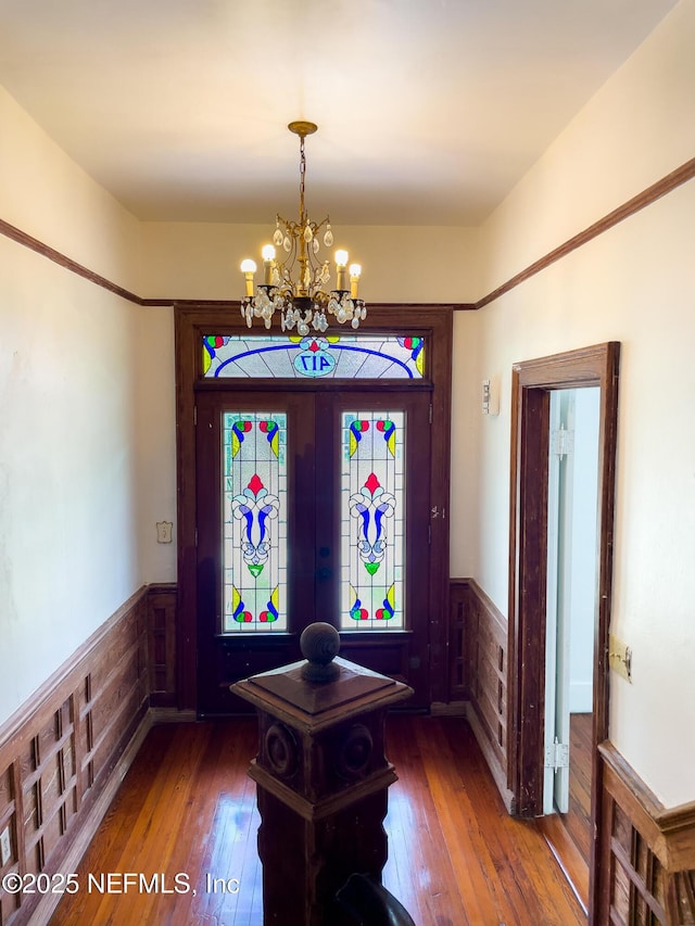 417 N 3rd St, Palatka, FL 32177 - entrance foyer featuring wainscoting, hardwood / wood-style floors, and a chandelier