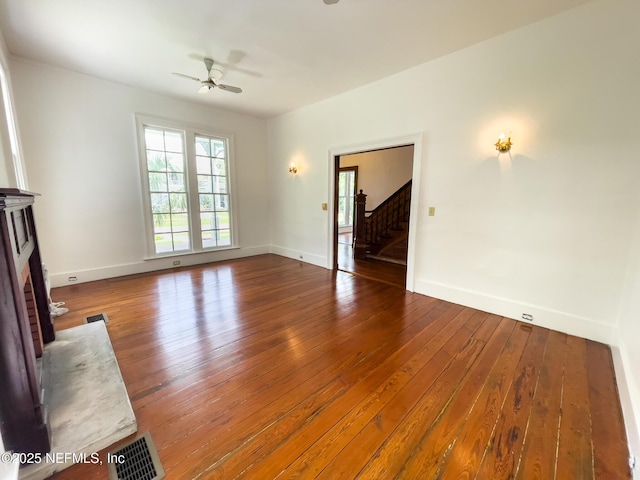 417 N 3rd St, Palatka, FL 32177 - unfurnished living room featuring a ceiling fan, hardwood / wood-style floors, stairway, and baseboards