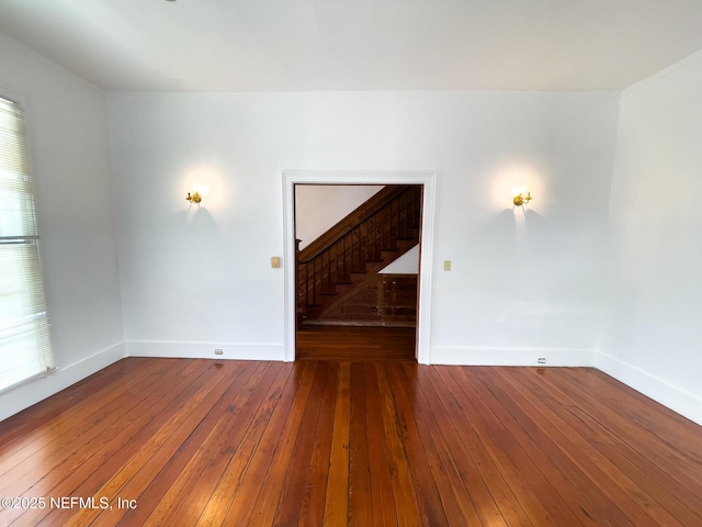 417 N 3rd St, Palatka, FL 32177 - spare room with stairway, hardwood / wood-style floors, and baseboards
