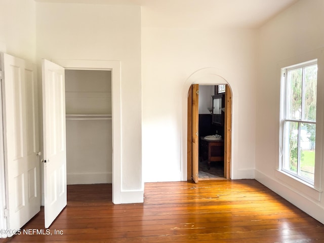 417 N 3rd St, Palatka, FL 32177 - unfurnished bedroom with hardwood / wood-style flooring, multiple windows, and a closet