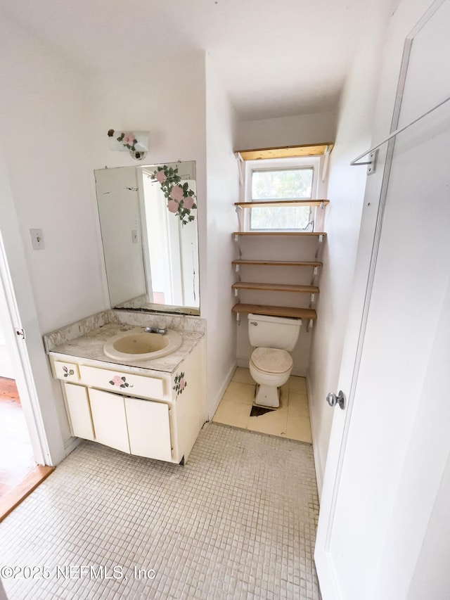 417 N 3rd St, Palatka, FL 32177 - bathroom with vanity, toilet, and tile patterned floors