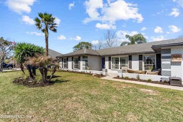 ranch-style home with brick siding and a front yard