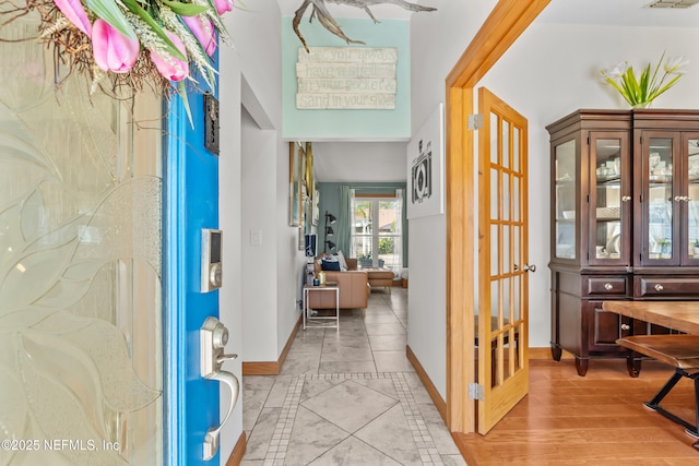 entryway with visible vents, baseboards, and light wood-style flooring