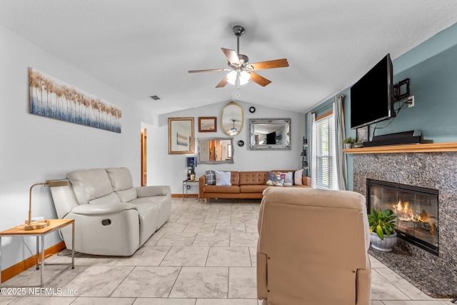 living room featuring a ceiling fan, baseboards, visible vents, lofted ceiling, and a fireplace