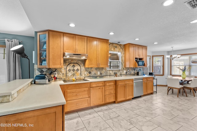 kitchen with visible vents, light countertops, under cabinet range hood, stainless steel dishwasher, and black electric cooktop