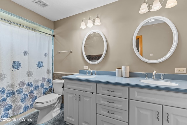 full bath featuring double vanity, toilet, visible vents, and a sink