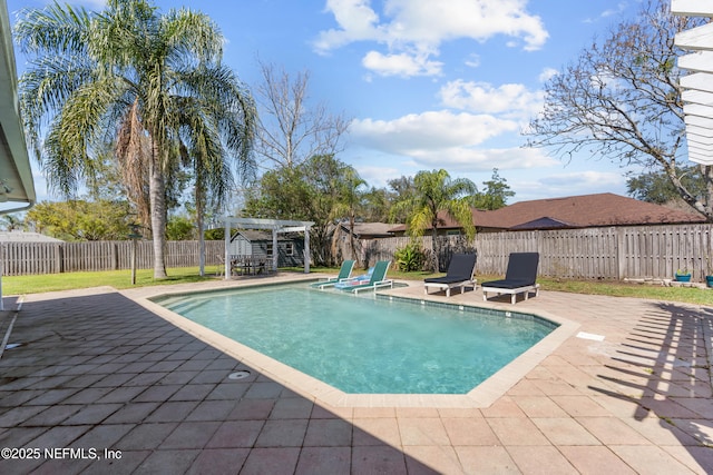 view of swimming pool with a patio area, a fenced in pool, a fenced backyard, and a pergola