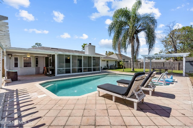 view of swimming pool with a pergola, a patio, fence, a sunroom, and a fenced in pool