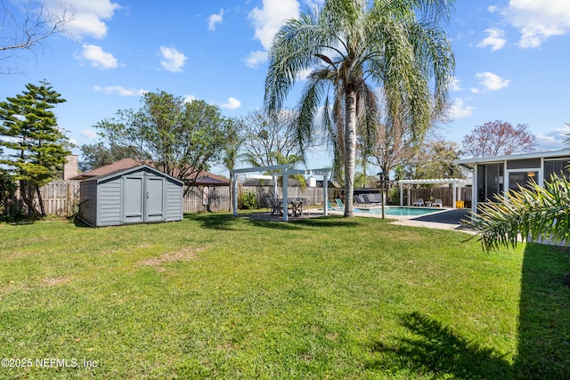 view of yard featuring an outbuilding, a fenced in pool, a fenced backyard, a pergola, and a storage unit