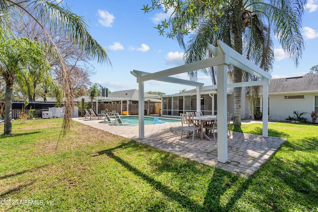 view of pool with a patio, a lawn, a sunroom, and fence