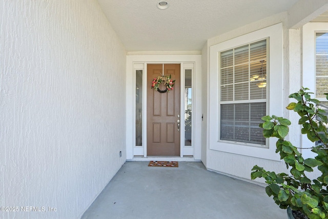 view of exterior entry featuring stucco siding