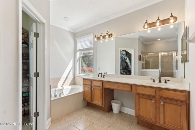 bathroom with a sink, a stall shower, a spacious closet, and ornamental molding