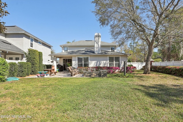 back of property with a patio, fence, a lawn, and stucco siding