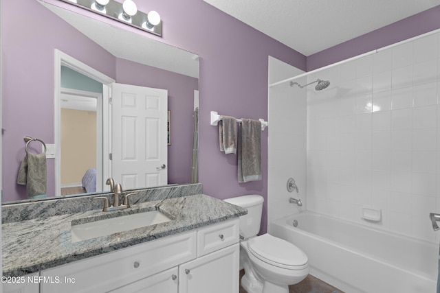 full bathroom featuring toilet, vanity, and bathtub / shower combination