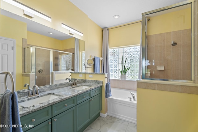 full bath featuring a shower stall, marble finish floor, a garden tub, and a sink