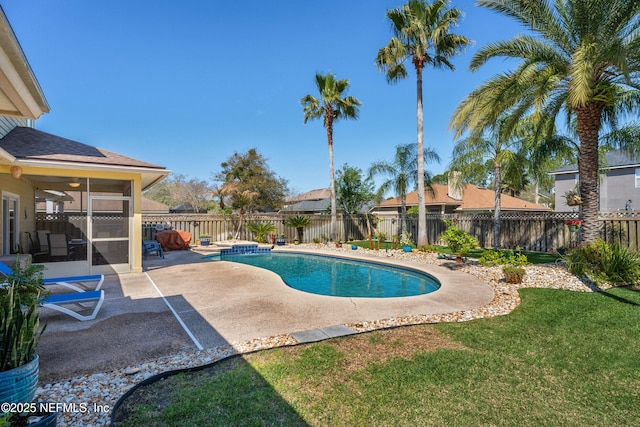 view of swimming pool featuring a lawn, a patio, a fenced backyard, a sunroom, and a fenced in pool