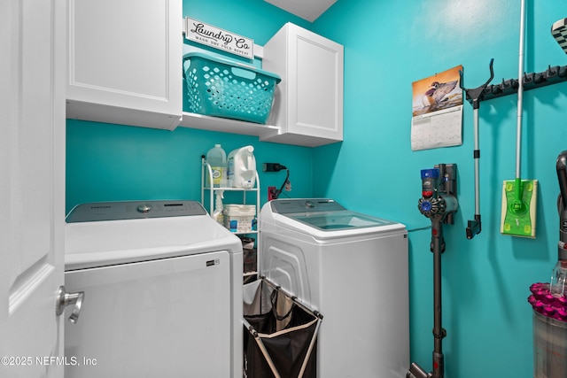 washroom featuring cabinet space and washer and dryer