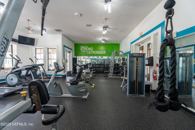 gym with visible vents and a textured ceiling