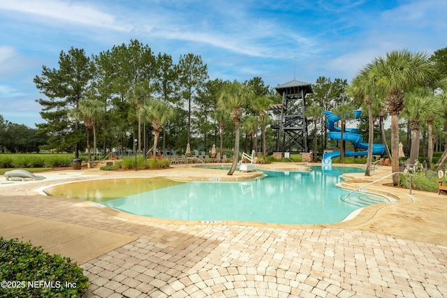 view of swimming pool with a water slide