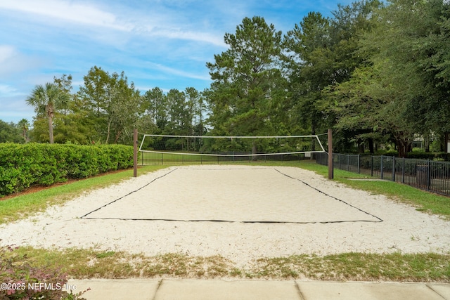 view of property's community featuring volleyball court and fence