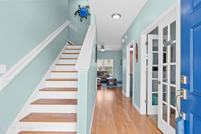 interior space with stairs, wood finished floors, and a ceiling fan