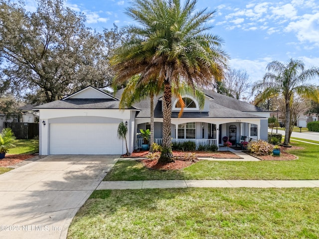 view of front of home featuring a front yard, covered porch, stucco siding, concrete driveway, and a garage